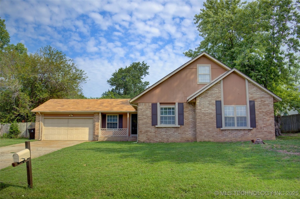 view of front of house with concrete driveway, an attached garage, fence, a front lawn, and brick siding