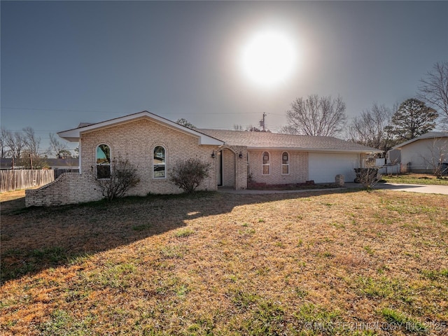 ranch-style house featuring brick siding, concrete driveway, fence, a garage, and a front lawn