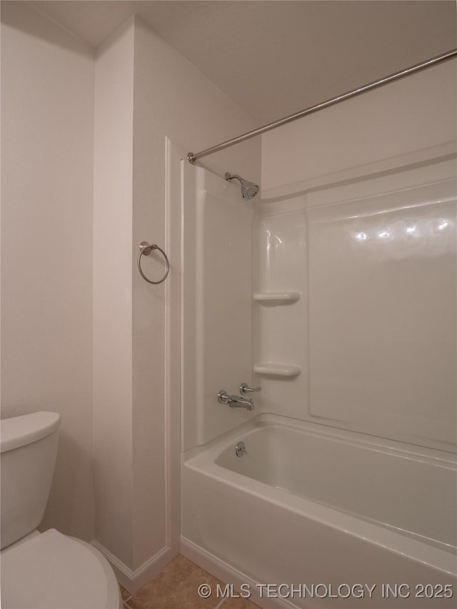 full bathroom with bathing tub / shower combination, tile patterned flooring, and toilet