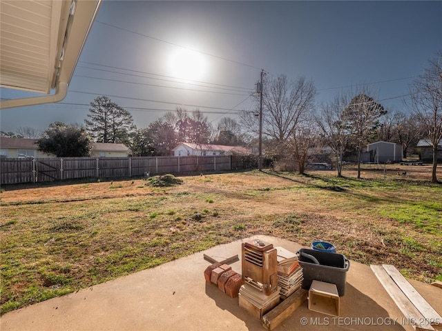 view of yard with fence and a patio