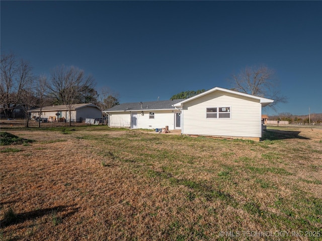 back of property with fence and a yard