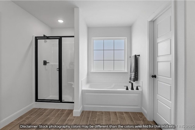 full bath featuring wood tiled floor, baseboards, a bath, and a shower stall