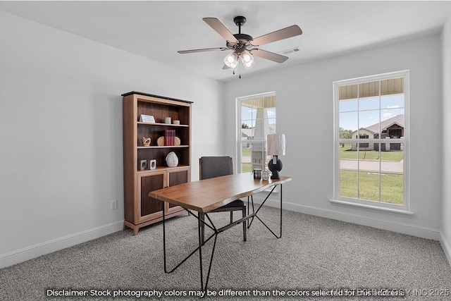 carpeted office space with a ceiling fan, visible vents, and baseboards