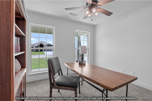 home office with ceiling fan, visible vents, baseboards, and light colored carpet