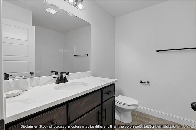 27983 E 109th St S, Coweta, OK 74014 - bathroom with wood tiled floor, baseboards, vanity, and toilet