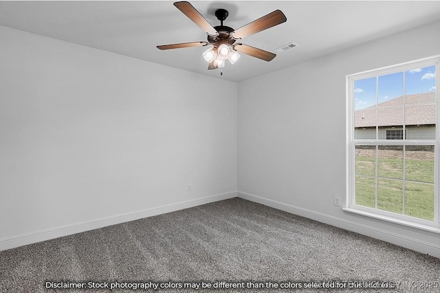 spare room with carpet floors, visible vents, baseboards, and a ceiling fan