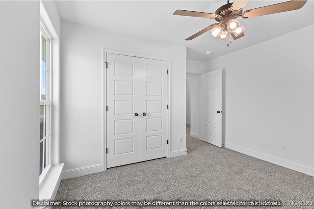 unfurnished bedroom featuring a closet, light colored carpet, and baseboards