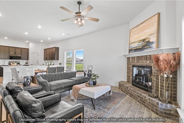27983 E 109th St S, Coweta, OK 74014 - living area with baseboards, a ceiling fan, wood finished floors, a brick fireplace, and recessed lighting