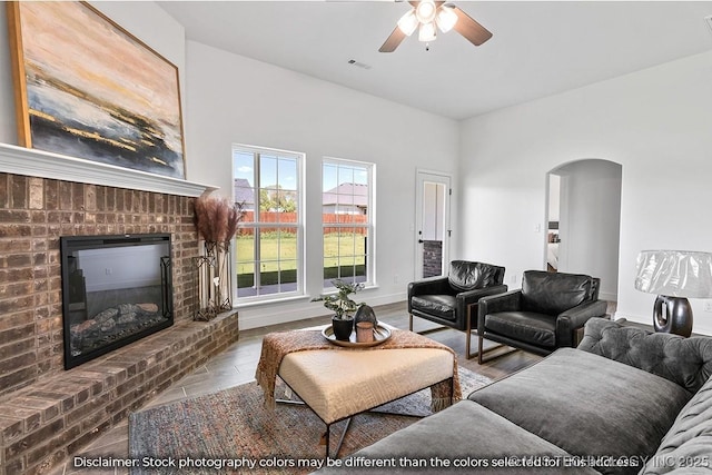27983 E 109th St S, Coweta, OK 74014 - living area with visible vents, arched walkways, baseboards, wood finished floors, and a brick fireplace
