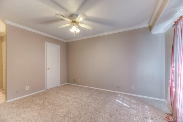 unfurnished room featuring baseboards, ornamental molding, a ceiling fan, and light colored carpet