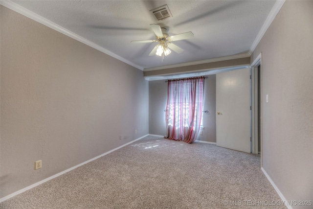 carpeted empty room featuring visible vents, crown molding, and a textured ceiling