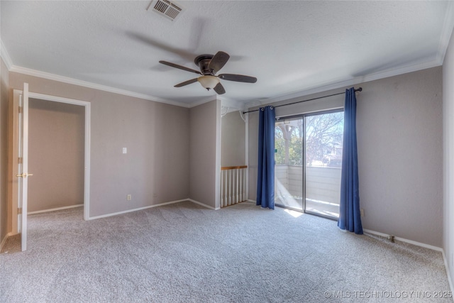 unfurnished room featuring baseboards, visible vents, a textured ceiling, and ornamental molding