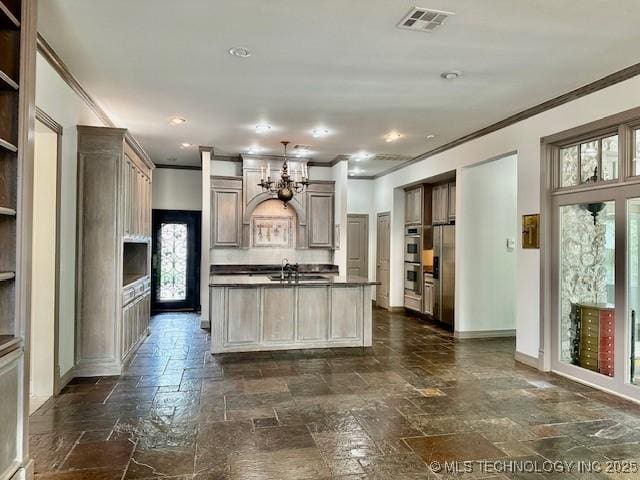 624 Sunset Dr SW, Ardmore, OK 73401 - kitchen with crown molding, a sink, stone tile floors, appliances with stainless steel finishes, and visible vents