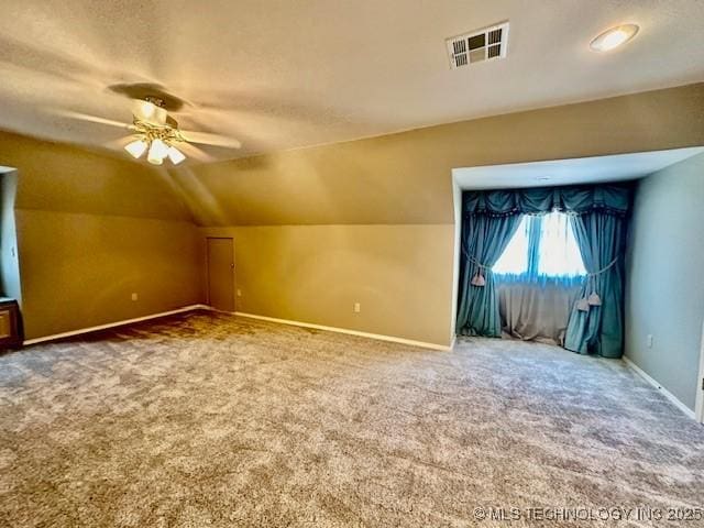 624 Sunset Dr SW, Ardmore, OK 73401 - additional living space with carpet, ceiling fan, baseboards, lofted ceiling, and visible vents