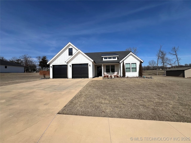 modern farmhouse style home with a garage, solar panels, board and batten siding, and driveway