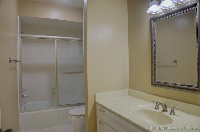 full bath featuring vanity, toilet, and bath / shower combo with glass door