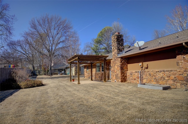 back of house featuring a patio, fence, stone siding, a pergola, and a chimney