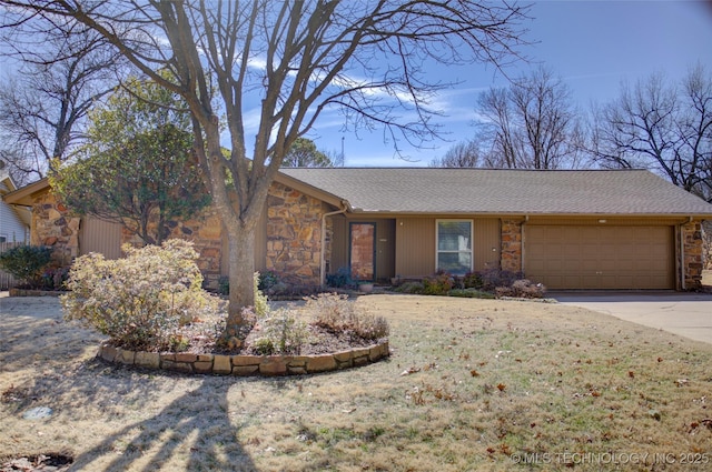 view of front facade with a garage, stone siding, and concrete driveway