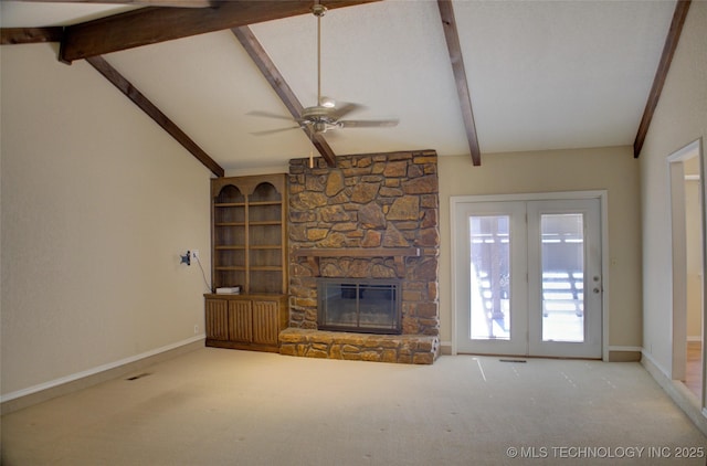 unfurnished living room featuring vaulted ceiling with beams, ceiling fan, a fireplace, carpet flooring, and baseboards