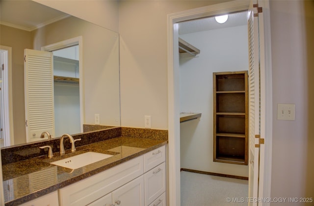 bathroom featuring crown molding and vanity