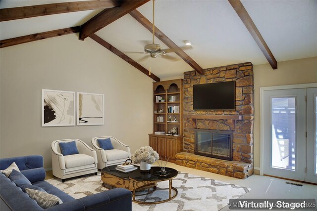 carpeted living room with lofted ceiling with beams, a fireplace, visible vents, and a ceiling fan