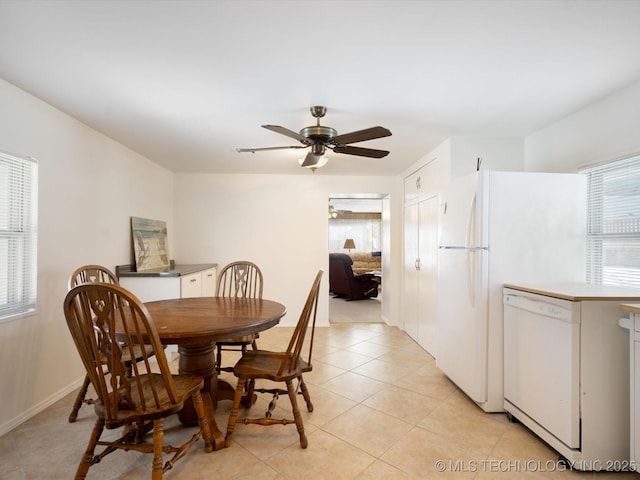 dining space with light tile patterned floors and ceiling fan