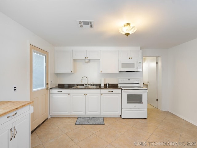 453576 Kaw Ave, Afton, OK 74331 - kitchen with white appliances, a sink, white cabinetry, and light tile patterned floors