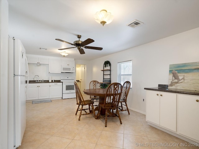 dining space with a ceiling fan, visible vents, baseboards, and light tile patterned floors