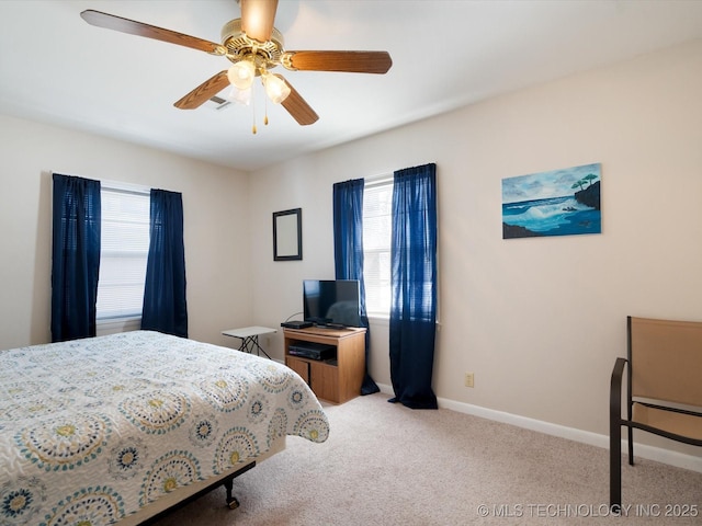 bedroom with light colored carpet, ceiling fan, and baseboards