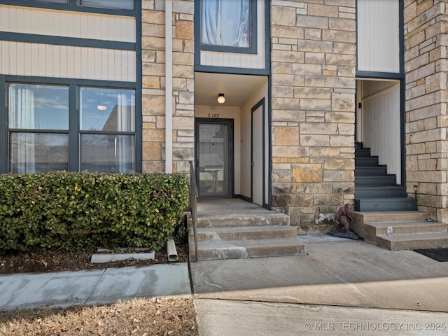 view of exterior entry featuring stone siding