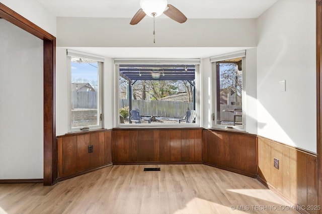 interior space with a ceiling fan and visible vents