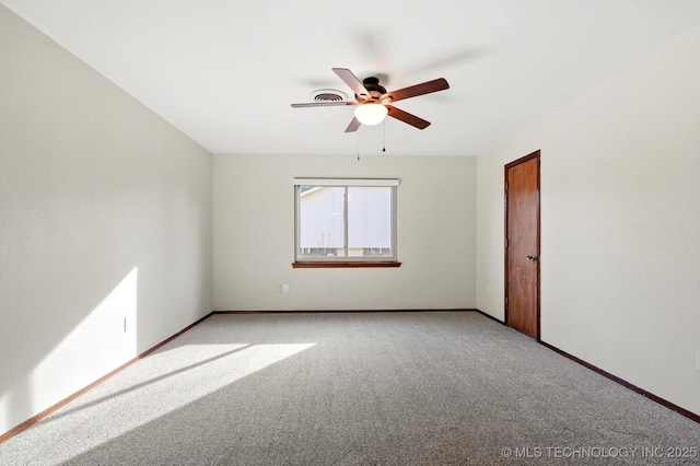 empty room with ceiling fan, baseboards, and light colored carpet