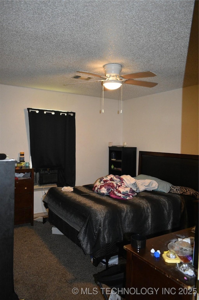 carpeted bedroom featuring a ceiling fan and a textured ceiling