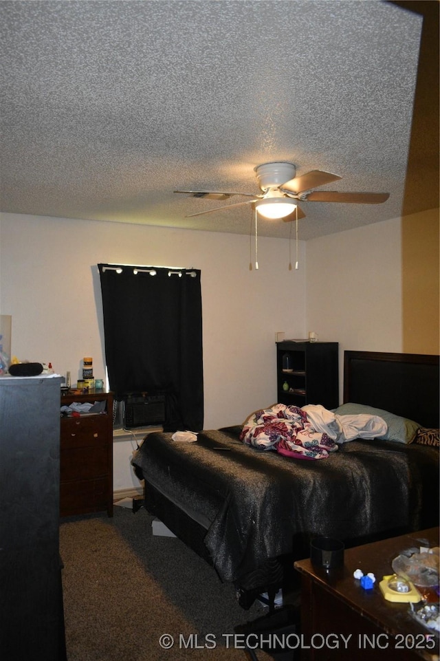 carpeted bedroom featuring a ceiling fan and a textured ceiling