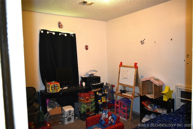 bedroom with a textured ceiling and visible vents