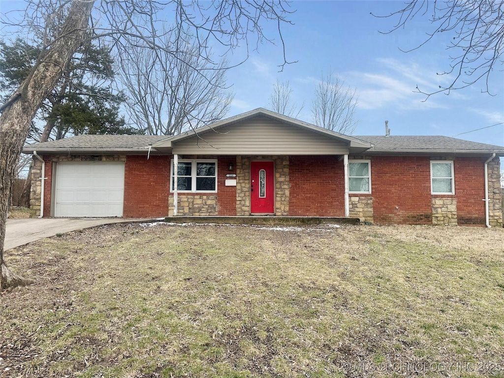 ranch-style house with driveway, stone siding, an attached garage, a front yard, and brick siding