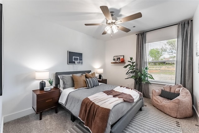 carpeted bedroom featuring a ceiling fan and baseboards