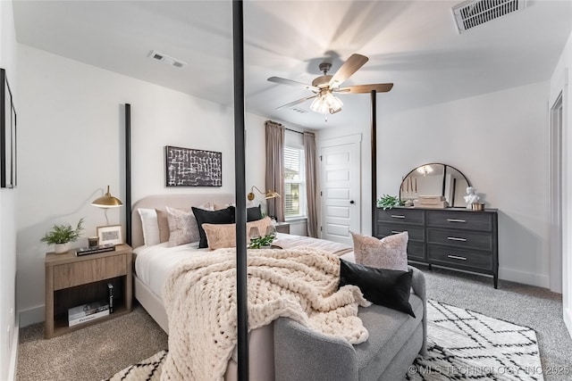 carpeted bedroom featuring baseboards, visible vents, and a ceiling fan