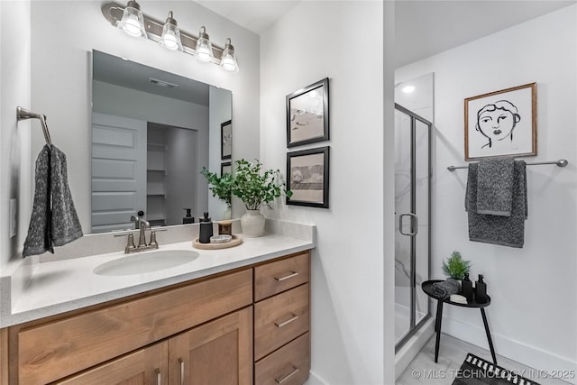 bathroom featuring a stall shower, baseboards, visible vents, and vanity