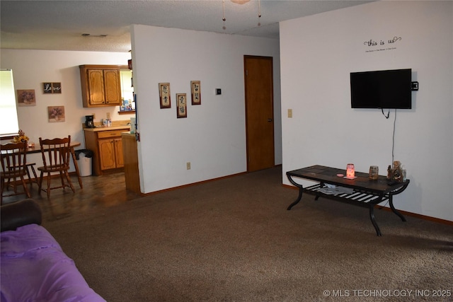 living room with dark carpet and baseboards