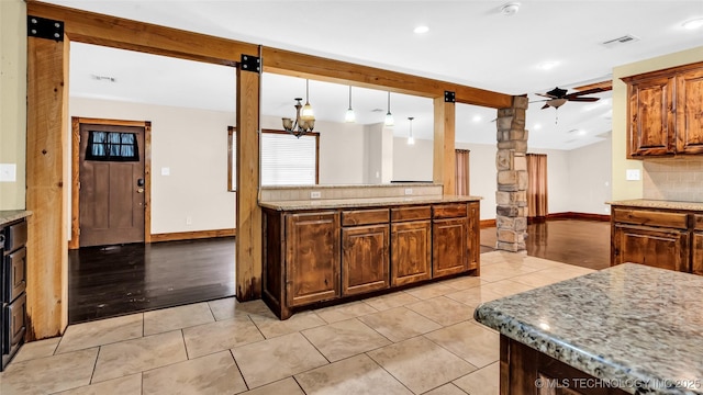 kitchen with baseboards, decorative backsplash, a ceiling fan, beam ceiling, and light tile patterned flooring