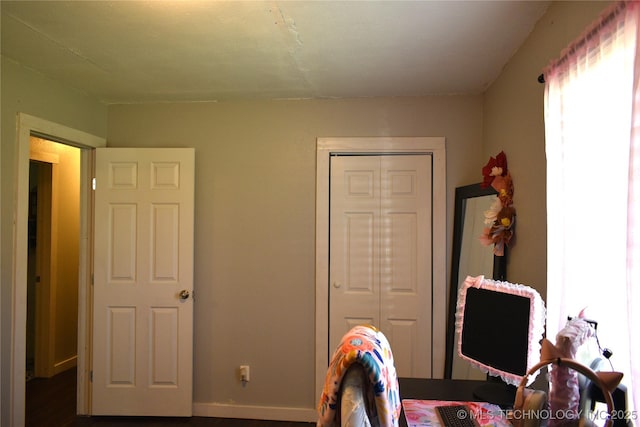 bedroom with a closet and baseboards