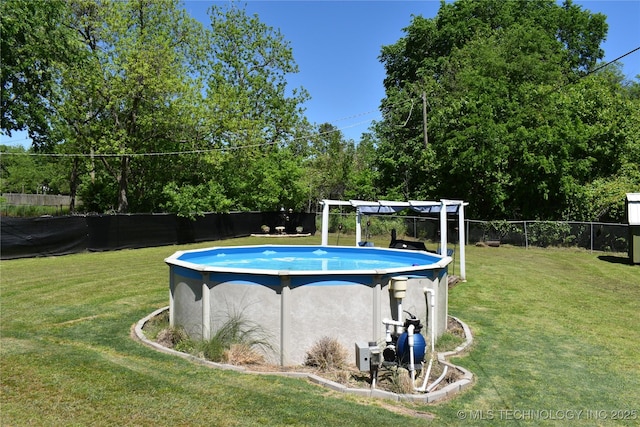 view of pool featuring a fenced in pool, fence, and a lawn