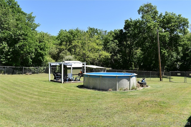 view of swimming pool featuring a fenced in pool, fence private yard, and a lawn