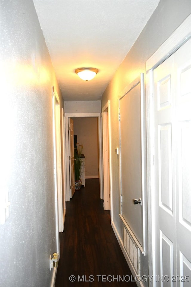 corridor featuring dark wood-type flooring