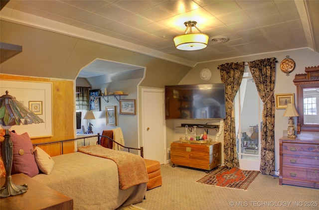 carpeted bedroom featuring vaulted ceiling and visible vents