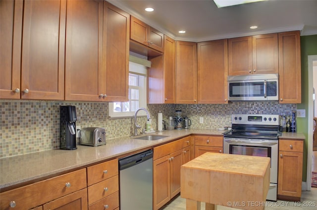 kitchen featuring appliances with stainless steel finishes, backsplash, a sink, and recessed lighting