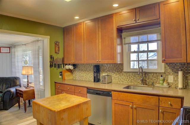 kitchen with recessed lighting, a sink, stainless steel dishwasher, backsplash, and brown cabinetry