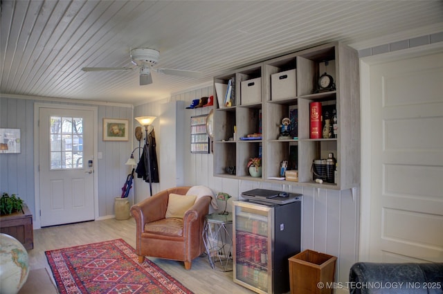 sitting room featuring wooden ceiling, light wood-style floors, and ceiling fan