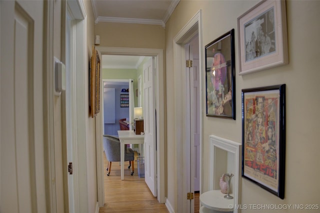 hallway featuring ornamental molding and light wood-type flooring